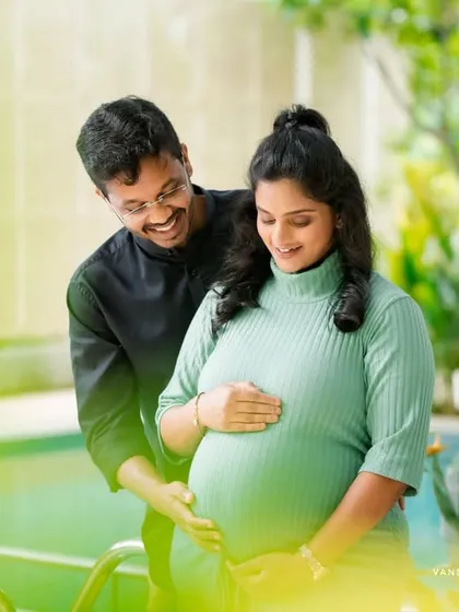 Capturing the pure joy and excitement of expecting. This candid poolside maternity photo highlights the couple's happy smiles and the beautiful baby bump.