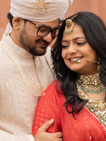 A close-up portrait of Nirzari and Hanshul, their coordinated wedding attire reflecting the regal theme of their celebration.