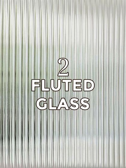 Fluted glass is our second trending material. Its vertical grooves offer privacy while allowing light to pass through, adding texture and elegance to doors and partitions.