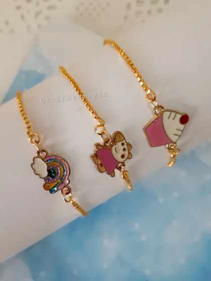 Another angle of the cute and affordable kids' charm bracelets, highlighting the rainbow, Peppa Pig, and cupcake charms.