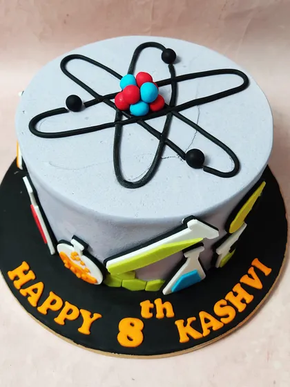 A cake for the curious mind, this Science Cake is topped with an atom and decorated with beakers, flasks, and lightbulbs.