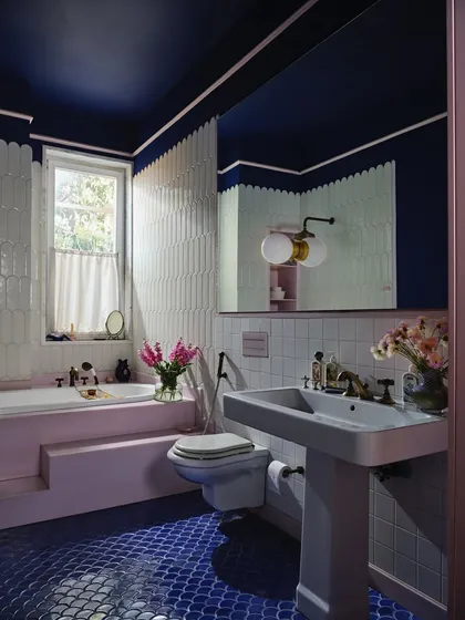 A bathroom can feel as personal as a journal. In the artist’s bath at The Blooming Garden, we used a bold palette of cobalt, blush, and indigo, with hand-painted ceramic tiles that serve as diary pages, making a functional space deeply personal and expressive.