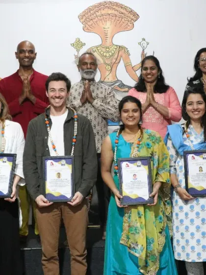 A group of students celebrating their 300 and 500-hour TTC certifications, a significant achievement in their yoga journey.