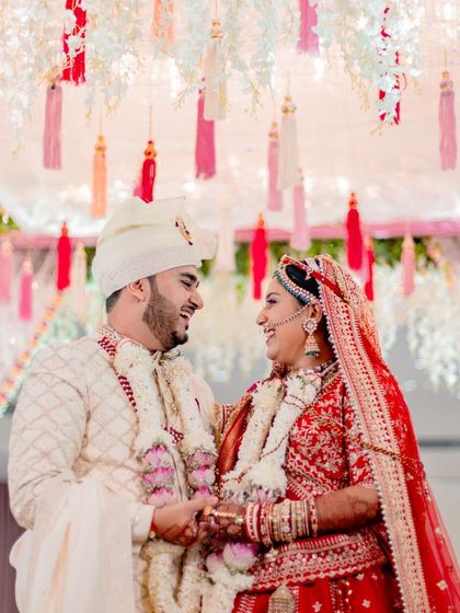 A candid shot of the couple sharing a laugh during their wedding ceremony. These unscripted moments of joy are just as important as the formal rituals in our wedding photography.