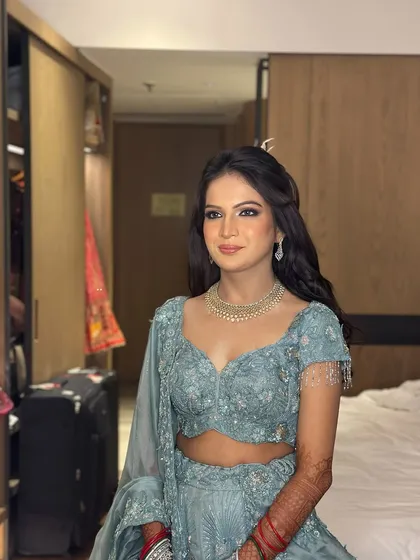 The bride-to-be, looking radiant with her half-up hairstyle for her engagement ceremony.