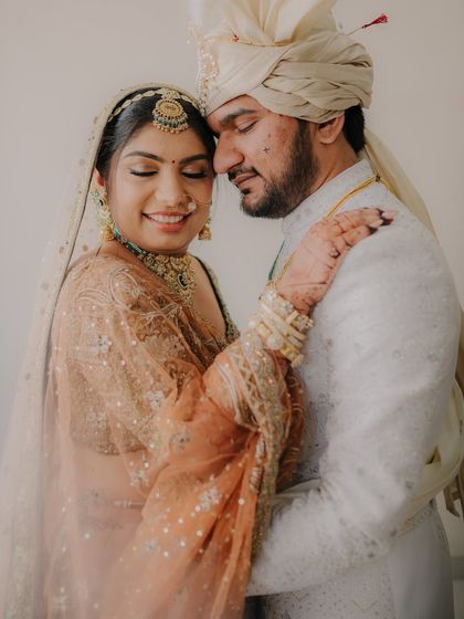 A warm and loving embrace. The couple's closed eyes and gentle smiles convey a sense of deep comfort and happiness in each other's arms.