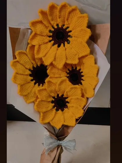 A full and sunny bouquet made entirely of bright yellow crochet sunflowers, perfect for anyone who loves this happy flower.