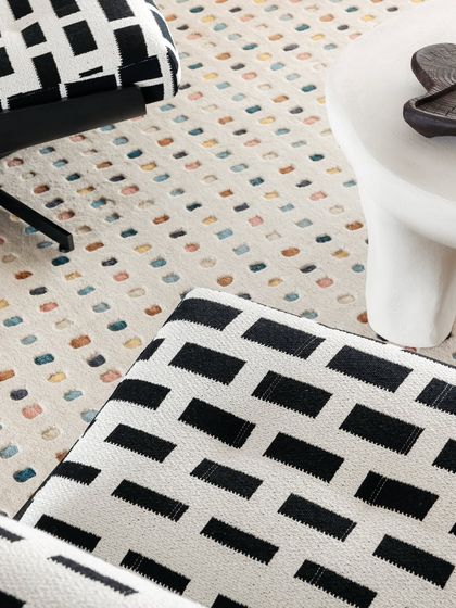 A close-up of the textures in the living room, from the multi-colored rug to the graphic print on the chair.