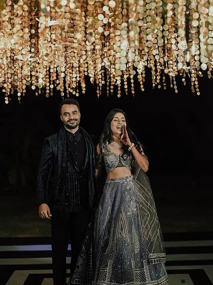 A full view of the couple under the stunning ceiling installation. The geometric dance floor and shimmering lights came together for a truly memorable reception look.