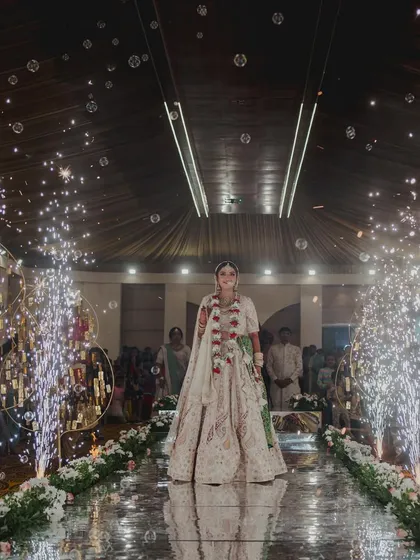The bride's grand entrance down a mirrored aisle. I lined the walkway with cold pyro fountains that erupted as she walked, creating a dazzling and dramatic path to her groom.