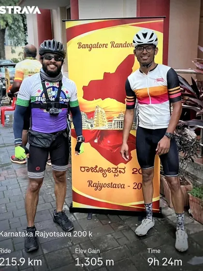Two of our riders posing at the finish of the Karnataka Rajyotsava 200k ride, with their Strava stats showing a 215.9 km journey. It's a proud moment of completion.