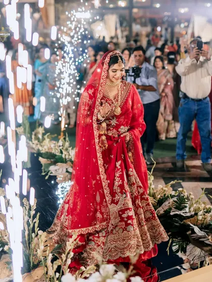 A stunning bridal entry, with the bride walking down an aisle lined with cold pyro fireworks, creating a path of light.