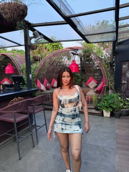 Walking towards the camera in the tie-dye dress.