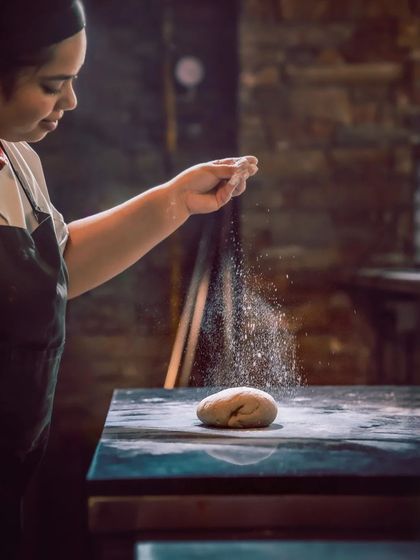 A chef dusts a ball of dough, crafted with the Japanese Yudane technique, free from adulterations and full of potential.