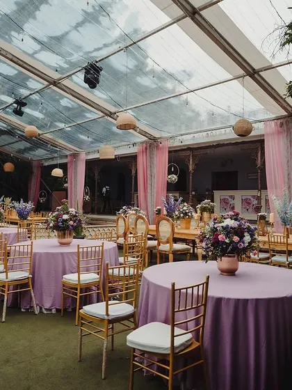 The pastel purple and pink theme continues through the table linens and floral arrangements.