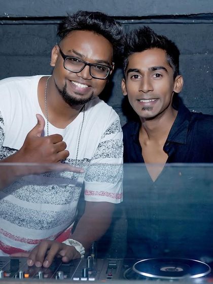 Posing with another DJ during a back-to-back set. Collaborating with other artists brings a fresh and dynamic energy to the party.