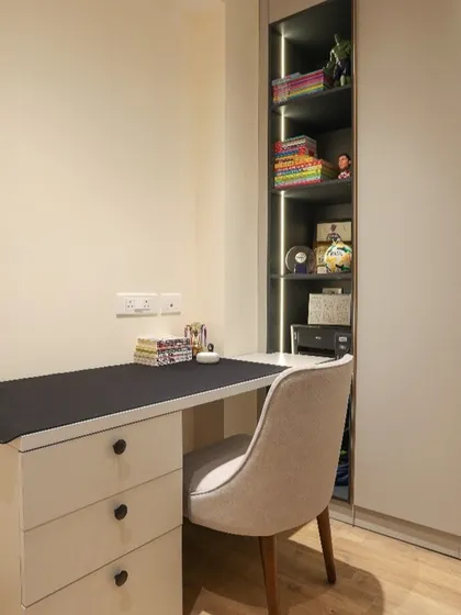 We designed this compact unit for a teen's room, combining a study desk with drawers and an adjoining storage unit with open, lit shelves and closed cabinets.