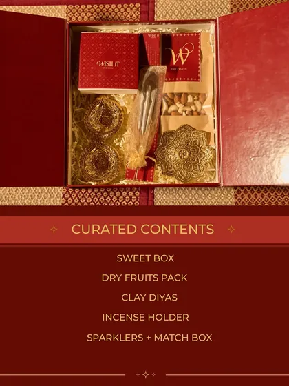 The curated contents of my traditional "Home Celebration Box" for Diwali. It includes a sweet box, dry fruits, clay diyas, an incense holder, and sparklers for a complete festive experience.
