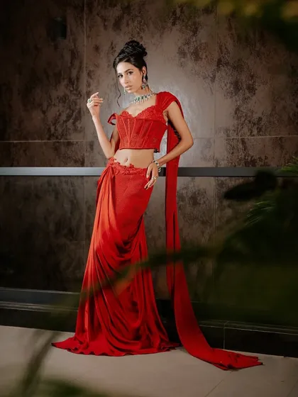 The corset is central to my work, and here it is redefined in a ruby red pre-draped sari. I paired the structured, tailored corset with fluid drapes to create a modern silhouette that honors tradition while feeling unapologetically new. It is designed to shape a new narrative of Indian wear.