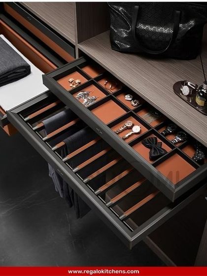 A complete organization system within a single drawer. This pull-out features a trouser rack, a tie and watch organizer, and a valet tray for a fully streamlined dressing experience.
