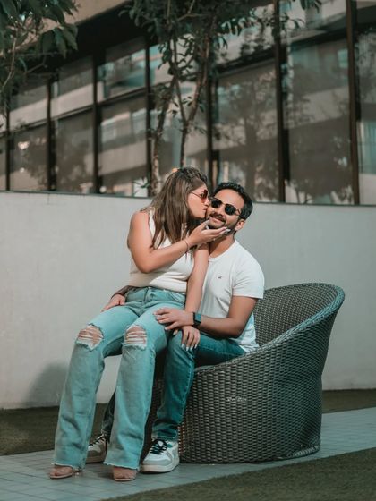 A playful and affectionate moment. This candid photo captures a sweet kiss, adding a touch of fun and romance to their urban pre-wedding collection.