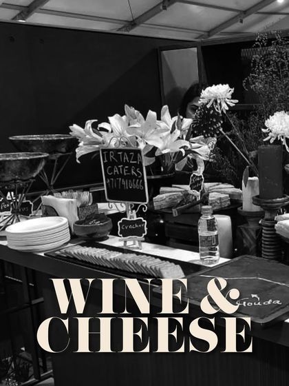 A black and white shot of our wine and cheese station, emphasizing the sophisticated and classic appeal of this catering option.