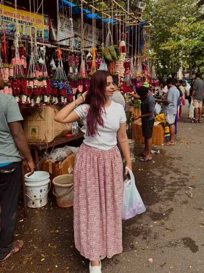 Shopping for flowers at a local market. Even on a busy day, a comfortable skirt and a basic t-shirt can be a stylish and practical outfit choice.