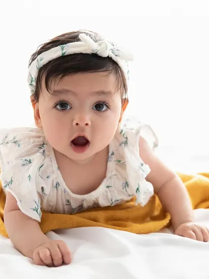 A look of pure wonder. This close-up captures the beautiful, wide-eyed curiosity of a baby exploring the studio.