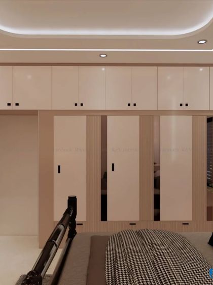 A bedroom with a full wall of white and wood-finished wardrobes, offering immense storage capacity.