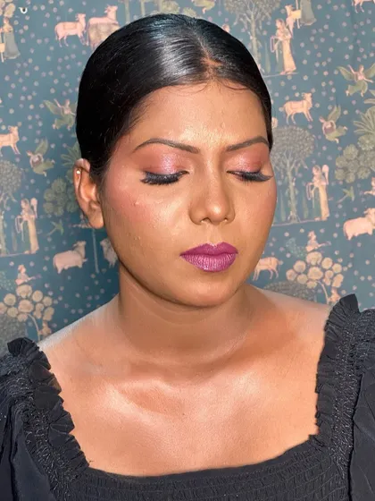 Another angle showing the beautiful blend of blush and highlighter on her skin, creating a radiant and healthy look.