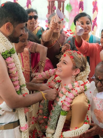 A candid moment of joy during the wedding rituals. The groom's traditional veshti drape remains perfectly in place, even amidst the celebration and movement.