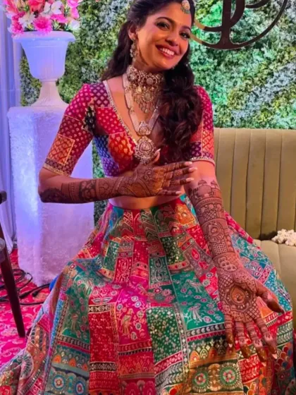 A stunning bride in her colorful lehenga, her detailed mehandi completing the festive look.