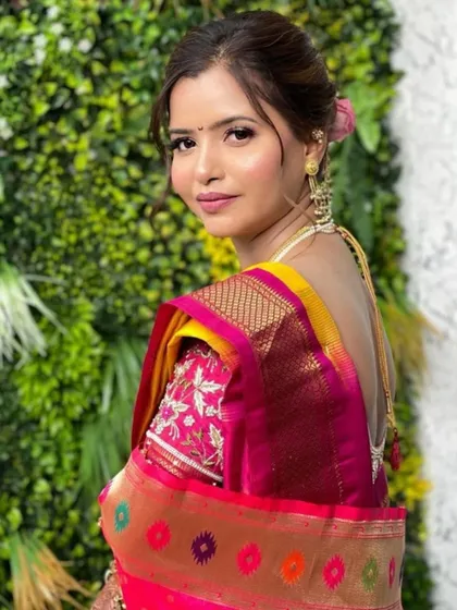 A back profile of Siddhi's Maharashtrian bridal look, showing off the beautiful saree drape and floral bun hairstyle.