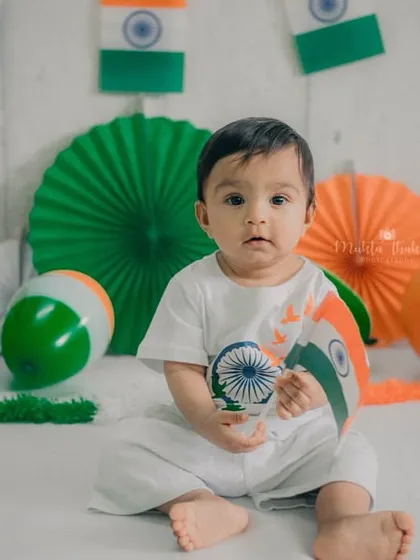 Posing with the tricolor, this little one looks so adorable in his themed outfit.