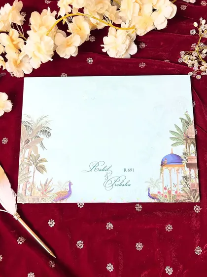 A simple and serene invitation envelope, featuring delicate illustrations of peacocks and palace gardens in a minimalist style.