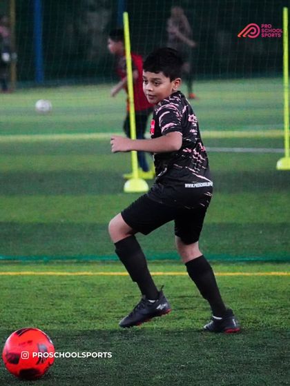 A player works on their dribbling through a slalom course, improving agility and ball control.