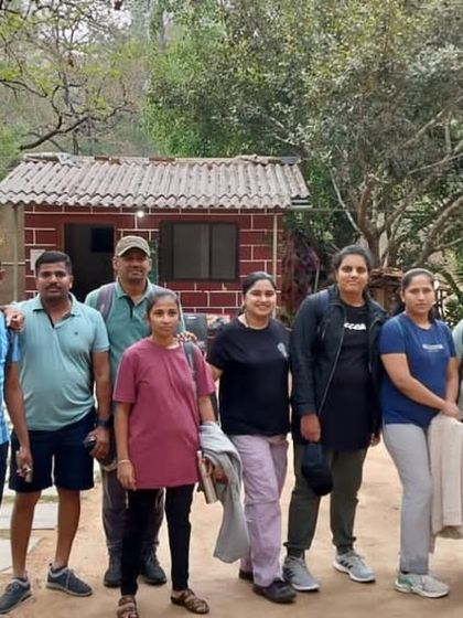 Our group ready to start the day's adventure, standing outside a rustic homestay near the Ulavi forest.