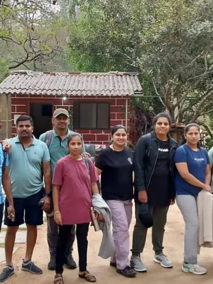 Our group ready to start the day's adventure, standing outside a rustic homestay near the Ulavi forest.