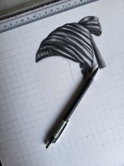 A close-up of the beginning stages of my Shivaji Maharaj portrait. I start with a precise grid to ensure accuracy, then slowly build up the layers of shading, as seen here on his iconic 'pheta' (turban).