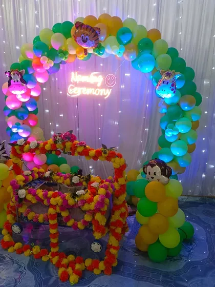 A full view of the jungle-themed naming ceremony with the decorated cradle.