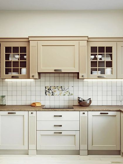 A classic and timeless kitchen design with shaker-style cabinets in a soft beige and white. We included glass-fronted upper cabinets for display and under-cabinet lighting for a warm, inviting glow.