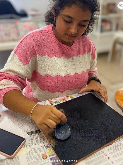 Prepping the canvas with a coat of black paint to make the colorful strings pop on the final name board design.