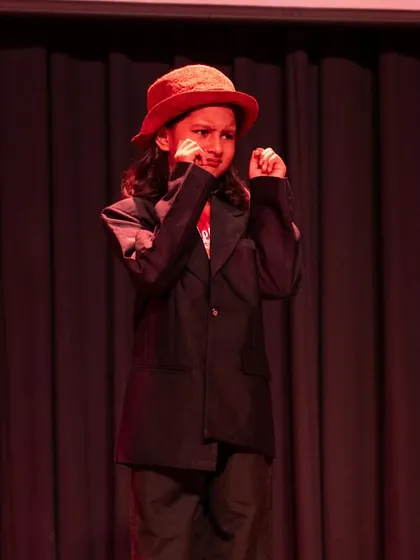 An actor portraying a comical, scheming character. We explore different genres, including comedy, which helps children develop timing and humor.