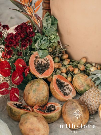A close-up of the tropical fruit and floral installation, with papayas and anthuriums.