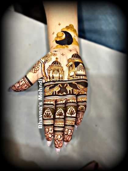 A scenic design for Karwachauth, with a beautiful night sky and architectural elements. This shows how creative you can get with mehndi.