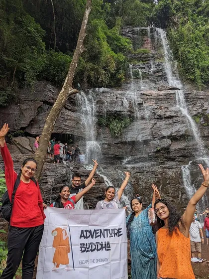 A group of women proudly holding our banner at a waterfall in Chikmagalur.