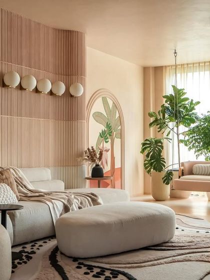 An overview of the "House of Mousse" living area, where curved sofas, a fluted feature wall, and layered textures create a harmonious and inviting atmosphere. The design encourages relaxation and connection.