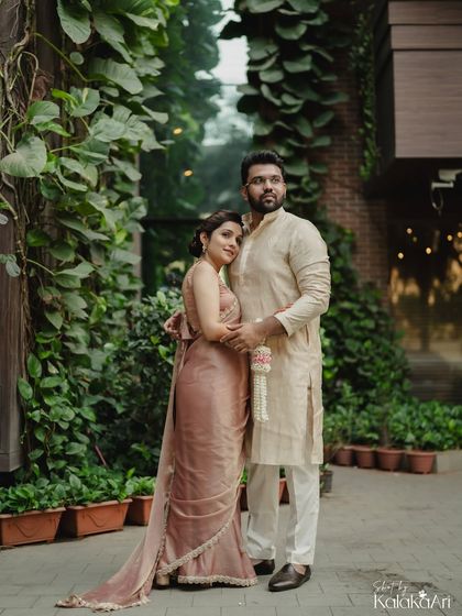 A classic portrait against a lush green backdrop. The couple's embrace and serene expressions create a timeless and elegant photo.
