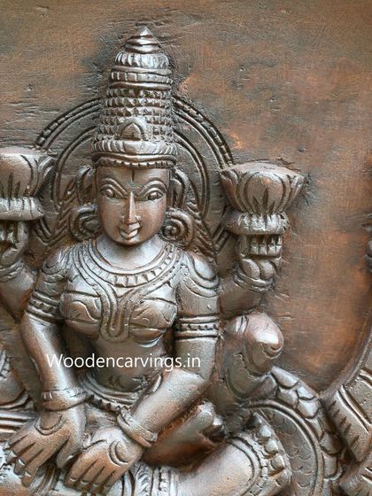 This detail shows Goddess Lakshmi attending to Lord Vishnu in the Narayanar panel, her form carved with grace and elegance.