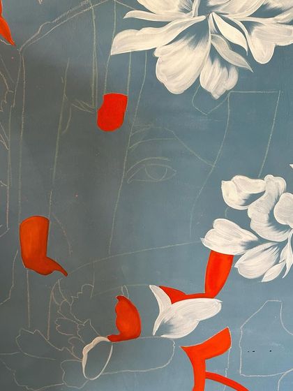 The process of creating art is about layering. Here, I'm adding white flowers over a blue background, with the initial orange sketch still visible underneath.